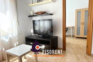 a living room with a tv and a table at Sol y Mar in Almería