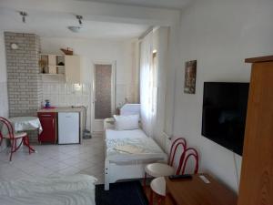 a living room with a couch and a kitchen at Ambient Apartments in Struga