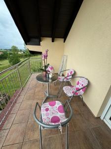 a patio with chairs and a table on a balcony at Ivan in Livno