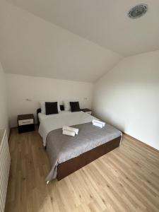 a bedroom with a bed with two towels on it at Ivan in Livno