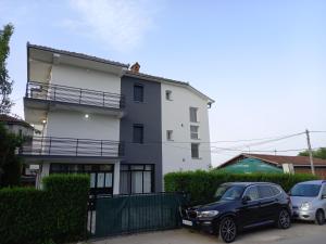 two cars parked in front of a building at Ambient Apartments in Struga