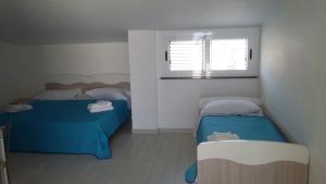 A bed or beds in a room at Casa Vacanza Miramare