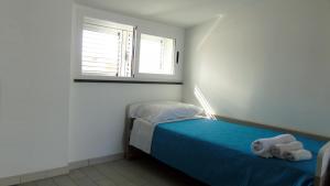 A bed or beds in a room at Casa Vacanza Miramare