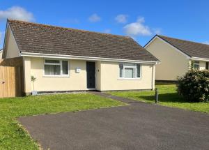 a house with a driveway in front of it at Cornish Coastal Bungalow in Padstow
