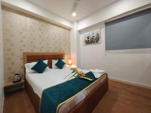 a bedroom with a bed and a large screen at Hotel PRASANG in Surat