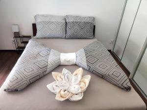 a bed with two flowers on top of it at Apartmán M&K WEST in Poprad +33 photos