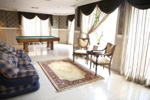 a living room with a pool table and chairs at Terrace Furnished Apartments - Mahboula in Kuwait