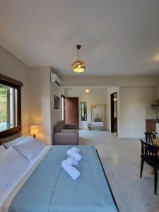a bedroom with a large bed with towels on it at Limnionas Apartments in Xorychti