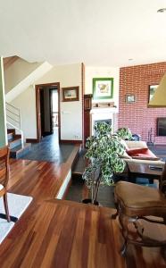 a living room with a table and a fireplace at Casa con piscina en Ajo - Las Arrañadas in Bareyo