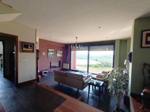 a living room with a couch and a table at Casa con piscina en Ajo - Las Arrañadas in Bareyo +13 photos