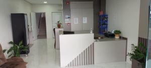 a white counter in a room with plants at HOTEL CALIFÓRNIA in Concordia