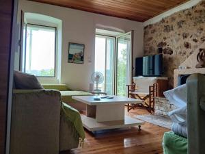 a living room with a couch and a table at MELPO in Évyiros