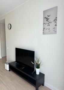 a living room with a flat screen tv at Dainas Apartment in Rīga