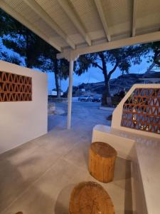 a wooden stump sitting on a floor next to a table at Golden Star in Ios Chora