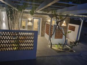 a house with a fence and a tree at night at Golden Star in Ios Chora