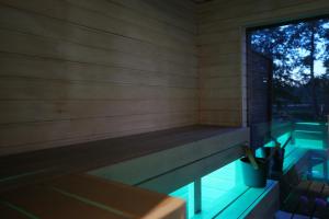 a swimming pool with a bench next to a window at Auksi puhkemaja-2 in Auksi