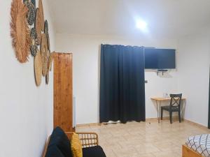 a living room with a blue curtain and a table at Ô'JASMIN in Mamoudzou
