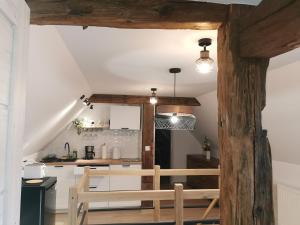 a kitchen with wooden beams and a wooden bench at Under the Hill 3 in Bad Muskau