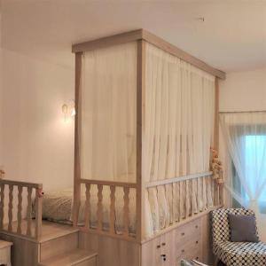 a baby crib with a canopy in a room at Laurel LK Houses in Kritinia Rhodes in Kritinía