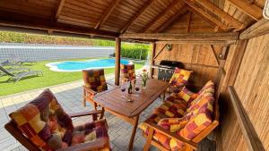a patio with a table and chairs and a pool at Villa Vital Hegykő in Hegykő