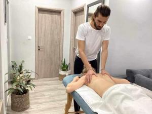 a man giving a woman a massage on a bed at Luxury Villa Anna Marittima in Limenas