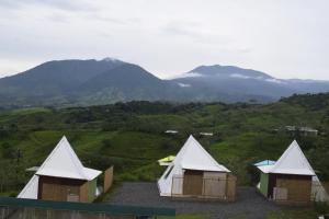 a group of three tents on a hill with mountains at Vistas Paraiso San Carlos in Venecia