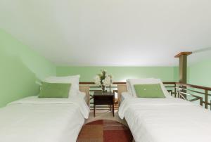 two beds sitting next to each other in a room at Vučković Studios in Kotor