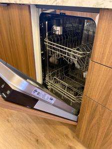 a dishwasher with racks of dishes inside of it at Apartamento en Casco Histórico in Pontevedra +16 photos