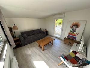 a living room with a couch and a table at Maison 3 à 5 Personne in Marigny