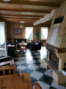 a living room with a fireplace and couches at Nina Kopalino in Kopalino