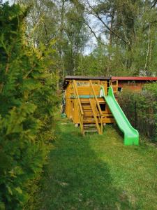 a playground with a green slide in the grass at Nina Kopalino in Kopalino +37 photos