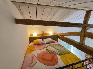 a bed in a room with two lights on it at Maison du Pont Canal in Agen