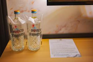 two bottles of water sitting on top of a table at Vodenica 3 Rooms in Duračka Reka