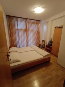 a bedroom with a large bed and a window at Prenociste Cazin in Cazin