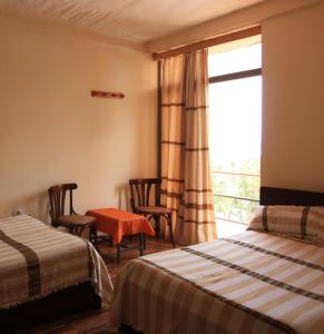 En eller flere senge i et værelse på Red Rock Lalibela Hotel