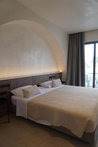 Postel nebo postele na pokoji v ubytování Ano Kampos Hotel + 14 fotografií