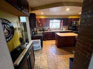 a kitchen with brown cabinets and a counter top at Stay with Jay - Segunda Room in Cleveland