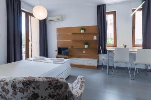 a bedroom with a bed and a table and chairs at View Apartments in Sozopol +93 photos