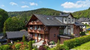 a large house in the middle of a mountain at Haus Daut FeWo mit Hallenbad in Willingen