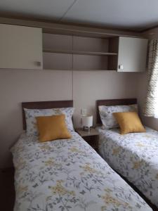 En eller flere senge i et værelse på 2 bed 2 ensuite Holiday Home
