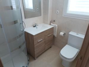 a bathroom with a toilet and a sink and a shower at Apartamento Tres Ce in Alcossebre +17 photos