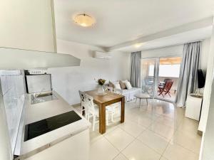 a kitchen and a living room with a table at Studio Katara Brela in Brela +23 photos