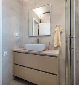 a bathroom with a sink and a mirror at Holiday home Val in Šibenik