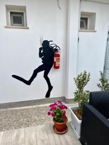 a mural of a woman running with a fire extinguisher at Vista Mare in Torre San Gennaro
