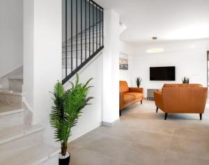 a living room with a couch and a tv at Holiday home Val in Šibenik