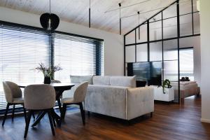 a living room with a couch and a table at Vila Vida in Palanga