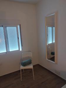 a white room with a chair and a mirror at Roque in Las Playitas