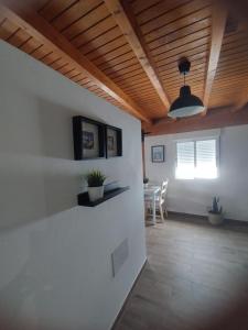 a living room with a wooden ceiling and a table at Roque in Las Playas +14 photos