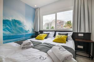 a bedroom with two beds and a large window at Ponderosa next to the pool apartments with big terraces close to the beach and Siam Park in Playa Fañabe +64 photos