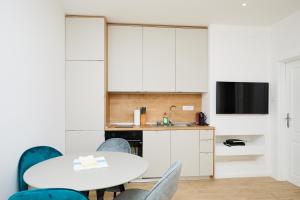 a kitchen and dining room with a table and chairs at Beloc House Lopud Island in Lopud Island
